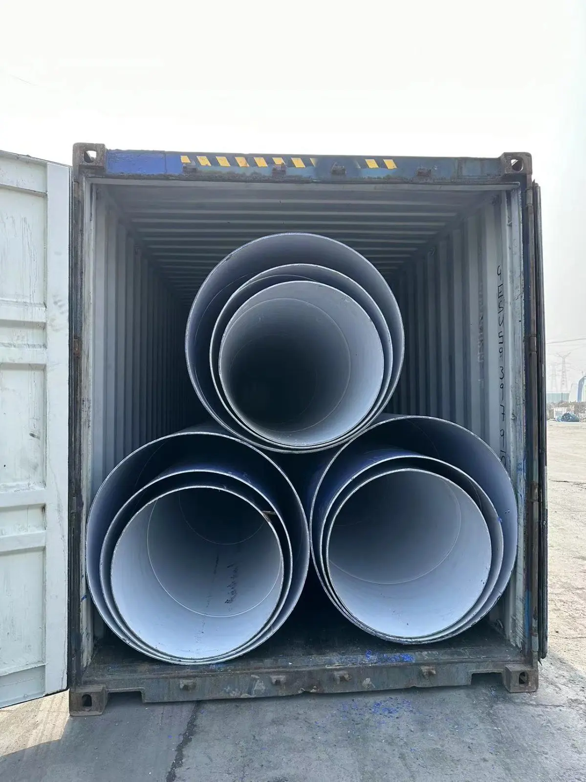 A container with three large pipes in it.